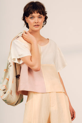 Model wearing peach and cream colour blocked Gaze top by Jennifer Glasgow. 