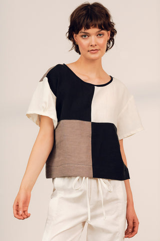 Model wearing black and clay colour blocked Gaze top by Jennifer Glasgow. 
