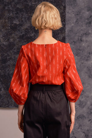 Back view of model wearing red Ikat Hania Blouse by Jennifer Glasgow. 