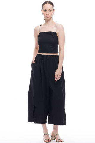 Woman wearing black tank top and black baloon Ling Pants by Toit Volante. 