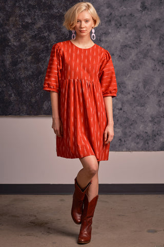 Model wearing red ikat Loktak dress by Jennifer Glasgow.