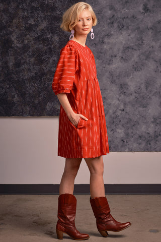 Side view of model wearing red ikat Loktak dress by Jennifer Glasgow.