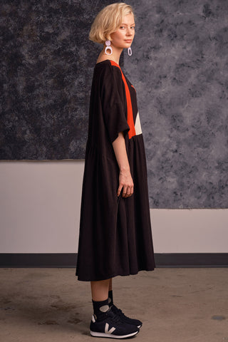 Side view of model wearing black and red colour blocked oversized Louella dress by Jennifer Glasgow. 