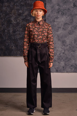 Model wearing floral shirt and black organic cotton Lozen pants by Jennifer Glasgow. 