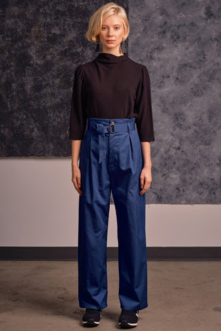 Model wearing black shirt and blue organic cotton Lozen pants by Jennifer Glasgow. 