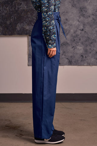 Side view of model wearing blue organic cotton Lozen pants by Jennifer Glasgow.