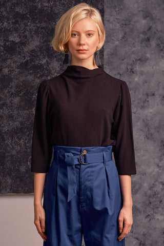 Model wearing black mock neck 3/4 length sleeve Maeve top by Jennifer Glasgow. 