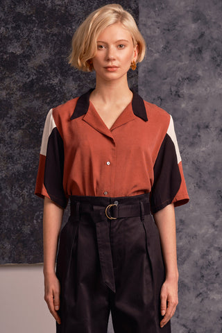 Model wearing rust, black and cream colour blocked button up Mavis shirt by Jennifer Glasgow.