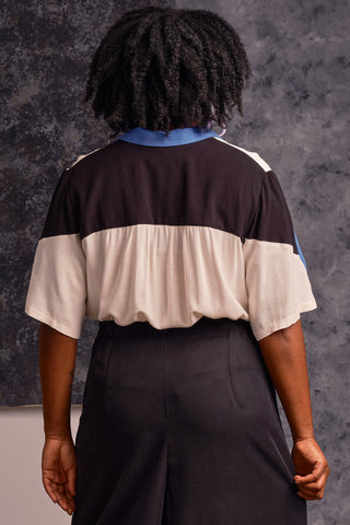 Back view of model wearing cream, black and cornflower blue colour blocked button up Mavis shirt by Jennifer Glasgow.