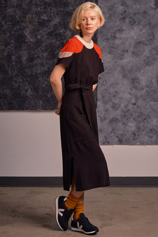 Model wearing midi length black and red colour blocked Meri Dress by Jennifer Glasgow. 