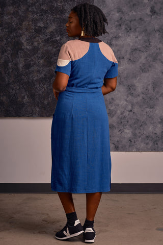 Back view of model wearing midi length royal blue and tan colour blocked Meri dress by Jennifer Glasgow. 