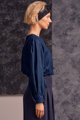 Side view of model wearing organic cotton blend denim button up Rosetta top by Jennifer Glasgow. 