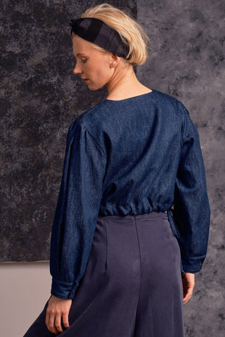 Back view of model wearing organic cotton blend denim button up Rosetta top by Jennifer Glasgow. 