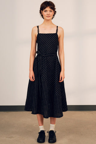 Woman wearing black stripe linen strappy Terra summer dress by Jennifer Glasgow. 