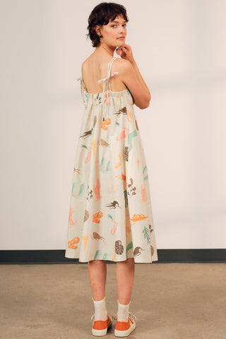 Back view of woman wearing printed linen organic cotton blend strappy Terra Sundress by Jennifer Glasgow. 
