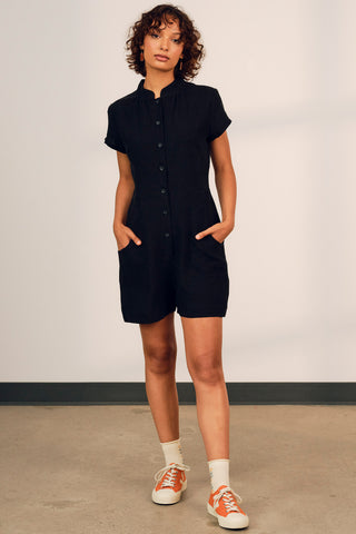 Model wearing black OEKO-TEK linen Thalassa jumpsuit by Jennifer Glasgow. 