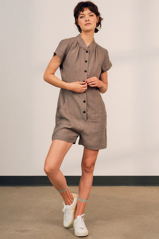 Model wearing grey OEKO-TEK linen Thalassa jumpsuit by Jennifer Glasgow. 