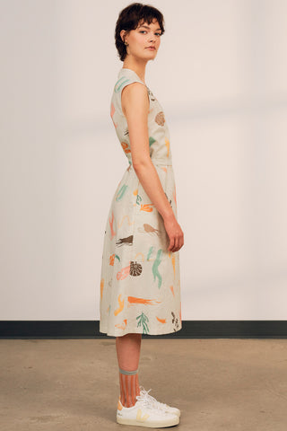 Side view of woman wearing exclusive JGD print midi length Ula wrap dress by Jennifer Glasgow.