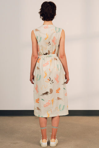 Back view of woman wearing exclusive JGD print midi length Ula wrap dress by Jennifer Glasgow.