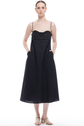 Woman wearing black midi length spaghetti strap Verona Dress by Toit Volante. 