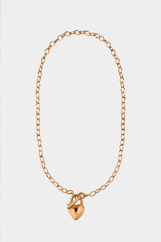 A gold chain necklace featuring a small heart-shaped padlock pendant with a tiny ruby in the center. 