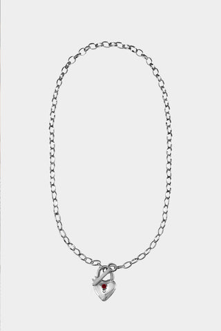 A silver chain necklace featuring a small heart-shaped padlock pendant with a tiny ruby in the center. 