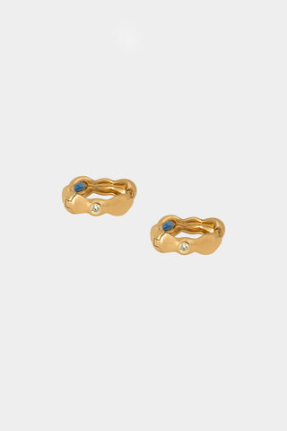 Gold hoop earrings with 3 embedded gemstones (brown, blue and yellow). 