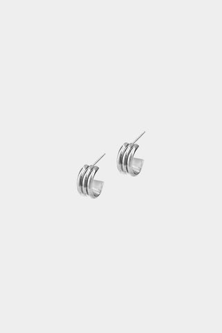 A pair of silver hoop earrings with triple-wire design, shown on a plain light gray background.