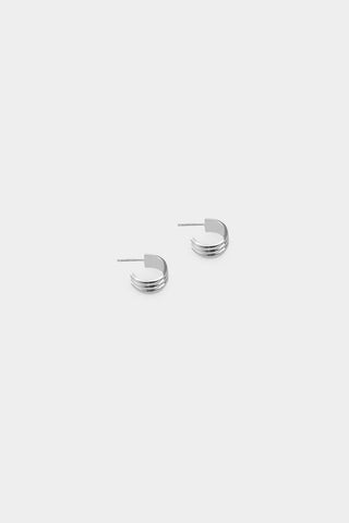 A pair of silver hoop earrings with triple-wire design, shown on a plain light gray background.