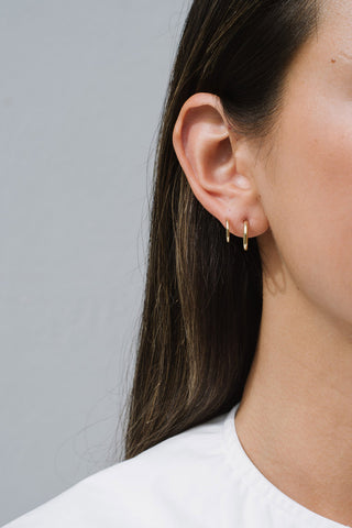Model wearing Kara Yoo Halow Faux Double Hoop earrings in sterling silver. 