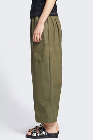 Side view of woman wearing olive wide leg patch pocket Aratus Pants by Kloke. 