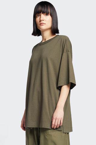 Woman wearing olive oversized unisex organic cotton Monolith tshirt by Kloke. 