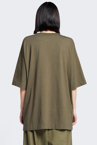 Back view of woman wearing olive oversized unisex organic cotton Monolith tshirt by Kloke. 