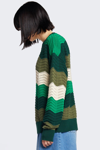 Side view of woman Green Wavy Ripple sweater by Kloke.