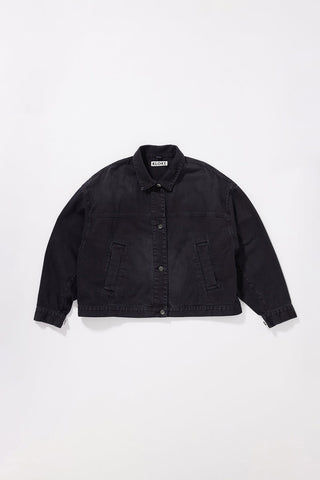 A black oversized denim jacket with a button-up front, collar, and two front  pockets, laid flat against a light gray background.