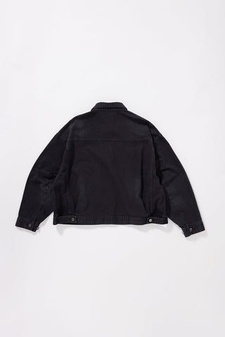 A black denim jacket shown from the back, laid flat against a clean white background.