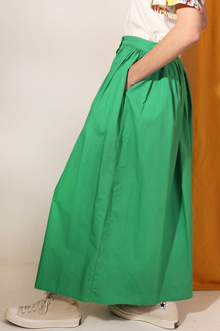 Side view of woman wearing green cotton poplin Isaac Skirt by LF Markey. 