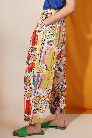 Woman wearing colourful Painted Paisley printed Mega Drawstring pants by LF Markey. 