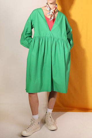 Woman wearing green poplin babydoll Warren dress by LF Markey. 
