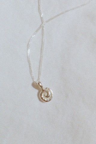 Sterling silver shell shaped pendant on chain. 