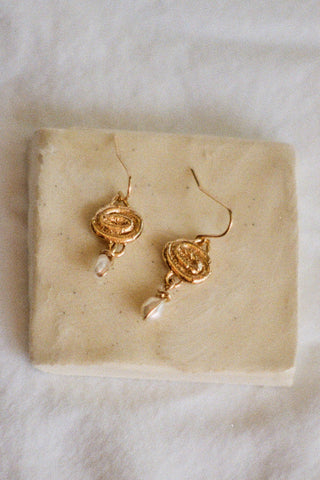 Gold vermeil hook earrings with dangling natural pearl. 