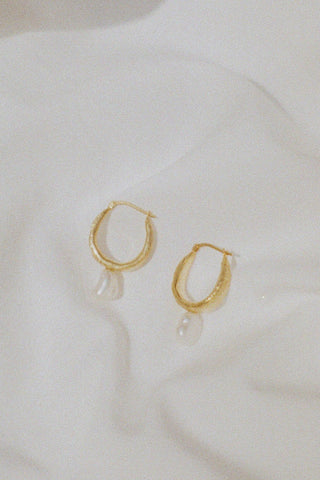 Gold vermeil sleeper hoop earrings with dangling natural pearl.