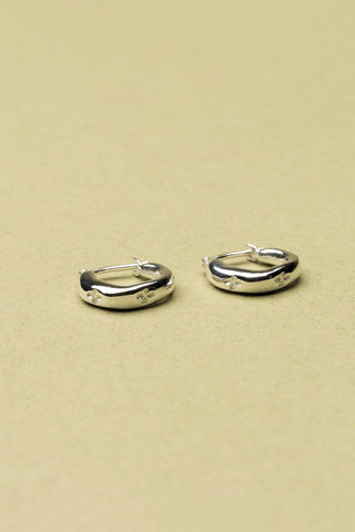 Sterling silver Aster sleeper hoop earrings by La Manufacture Fait Main. 