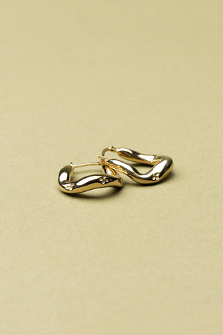 Gold vermeil Lupin Sleeper hoop earrings by La Manufacture Fait Main. 