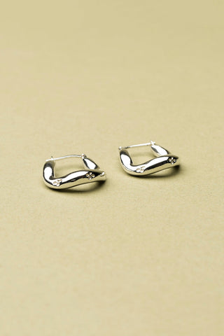 Sterling silver Lupin sleeper hoop earrings by La Manufacture Fait Main. 