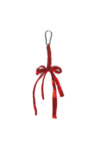 Metallic scarlet red crocheted bag charm on white background. 