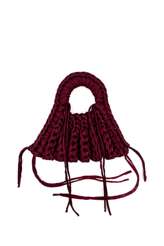 Deep wine red crocheted handbag on white background. 