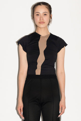 Woman in front of white background wearing black cap sleeve top with mesh insert detail on front. 
