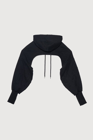 A back view of black bolero hoodie with voluminous balloon sleeves, shown against a light gray background.