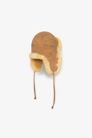 Side view of light brown shearling Aviator Hat by Milo & Dexter. 